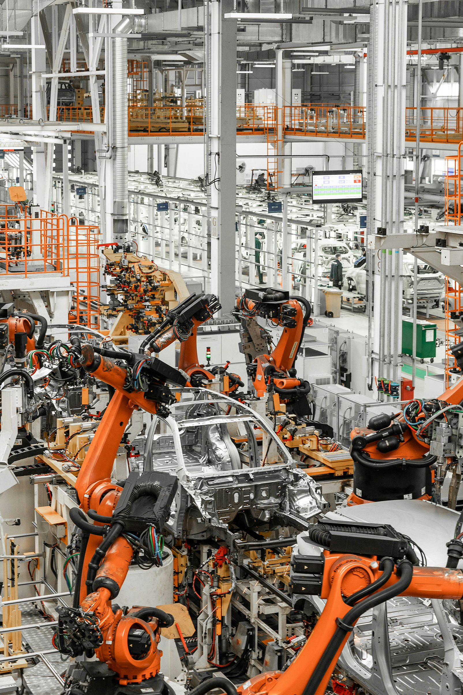 Robotic arms on an automotive production line